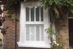 Sash window with plantation shutters