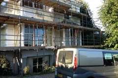 Sash window repair house with scaffolding van parked outside