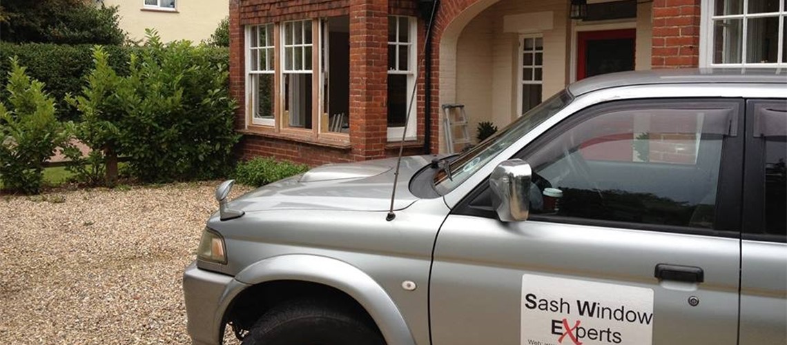 Period house with sash windows and Sash Window Experts van parked outside